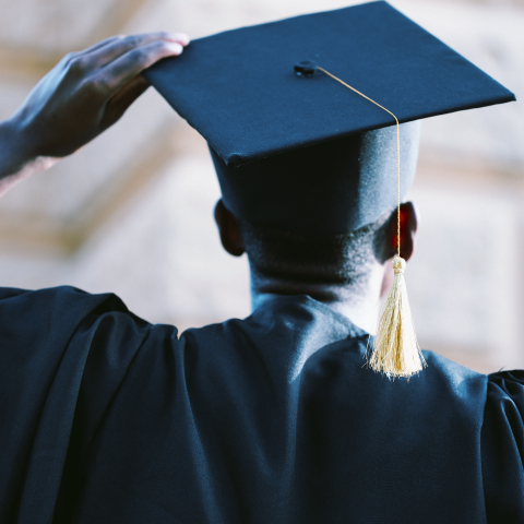 A black student in a graduation cap.